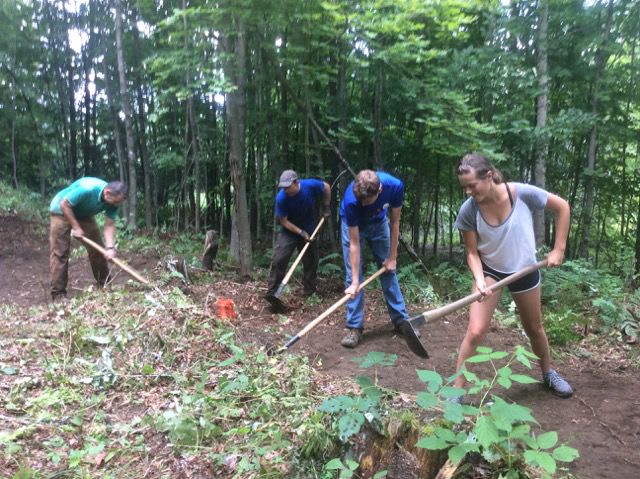 Local KSTP volunteers work on shaping a trail feature.jpeg